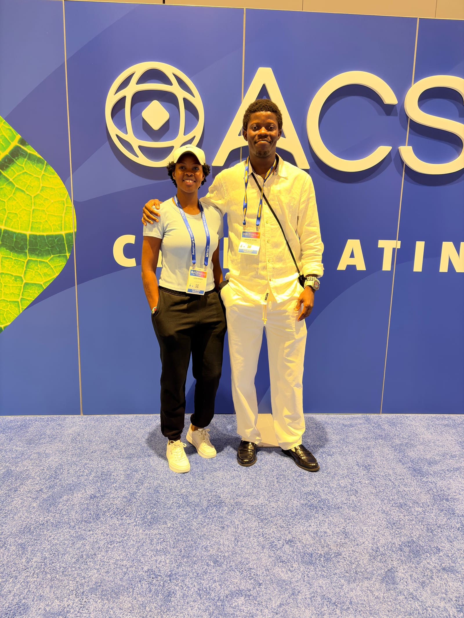 Abiodun Idowu with another conference attendee in front of an ACS Fall backdrop